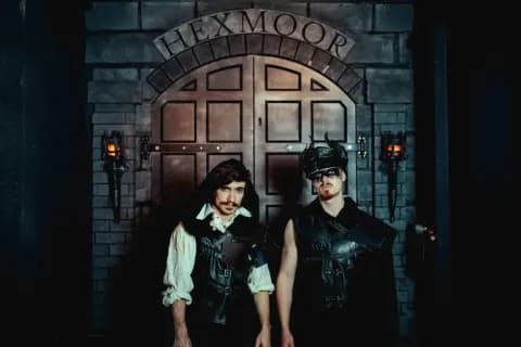 Two Hexmoor characters standing before the wizarding prison gates